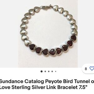 Sterling silver and garnet heart bracelet with safety chain.